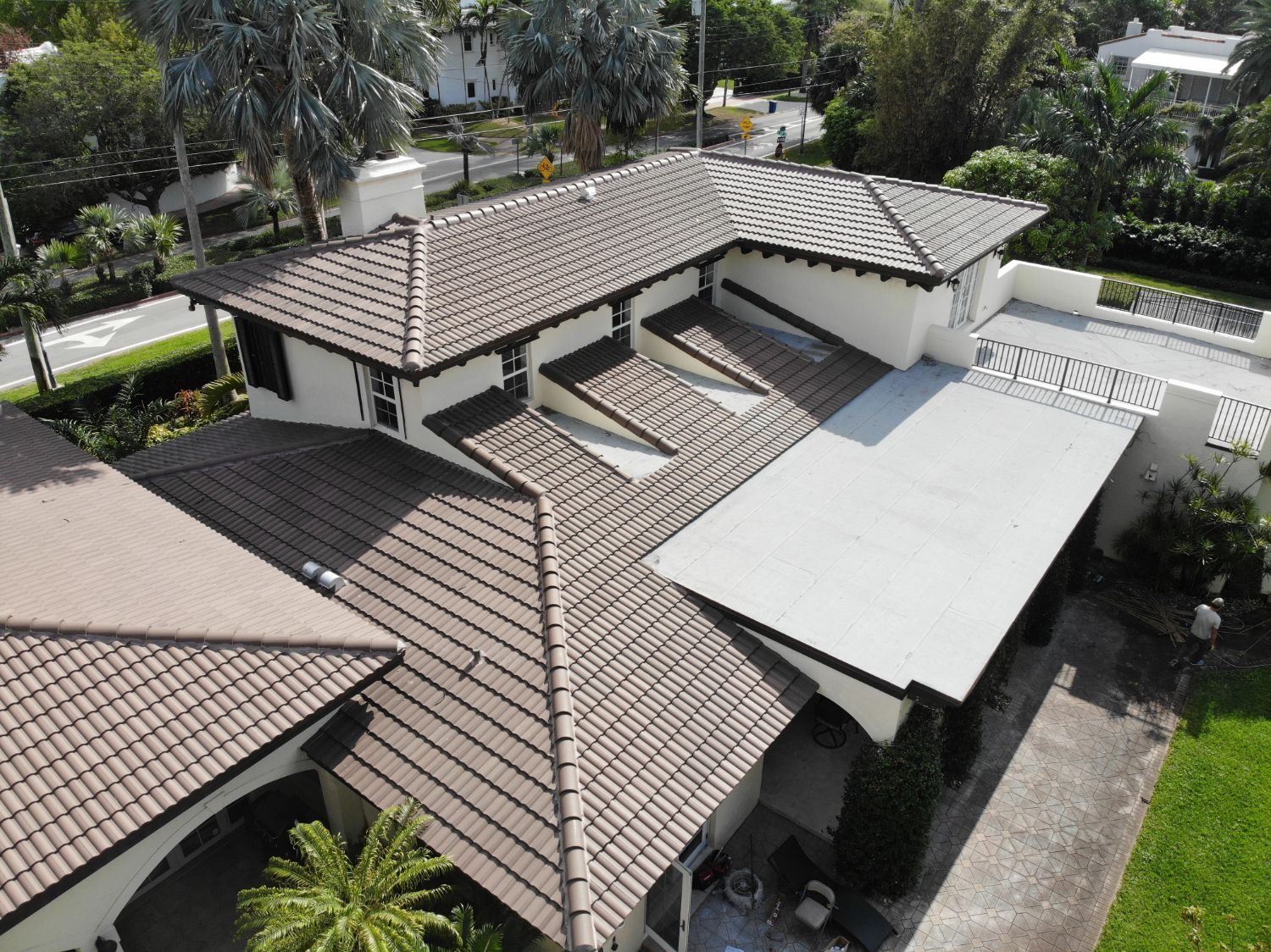 Brown barrel tile roof combined with a flat roof section on a South Florida home
