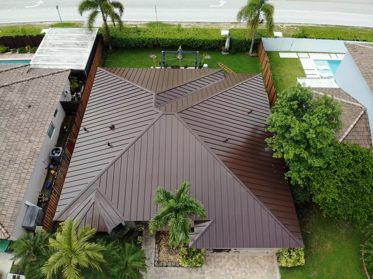 Aerial view of a brown standing-seam metal roof on a South Florida home