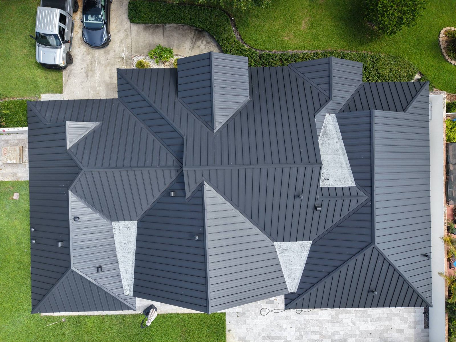 Aerial view of a charcoal standing-seam metal roof installed by Skymen Roofing