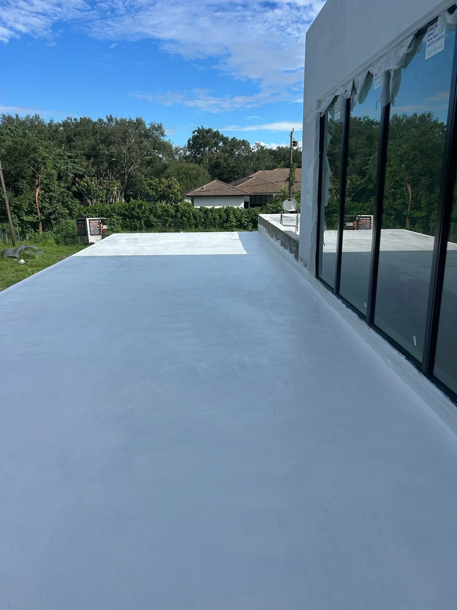 Finished white waterproof coating on a flat roof deck