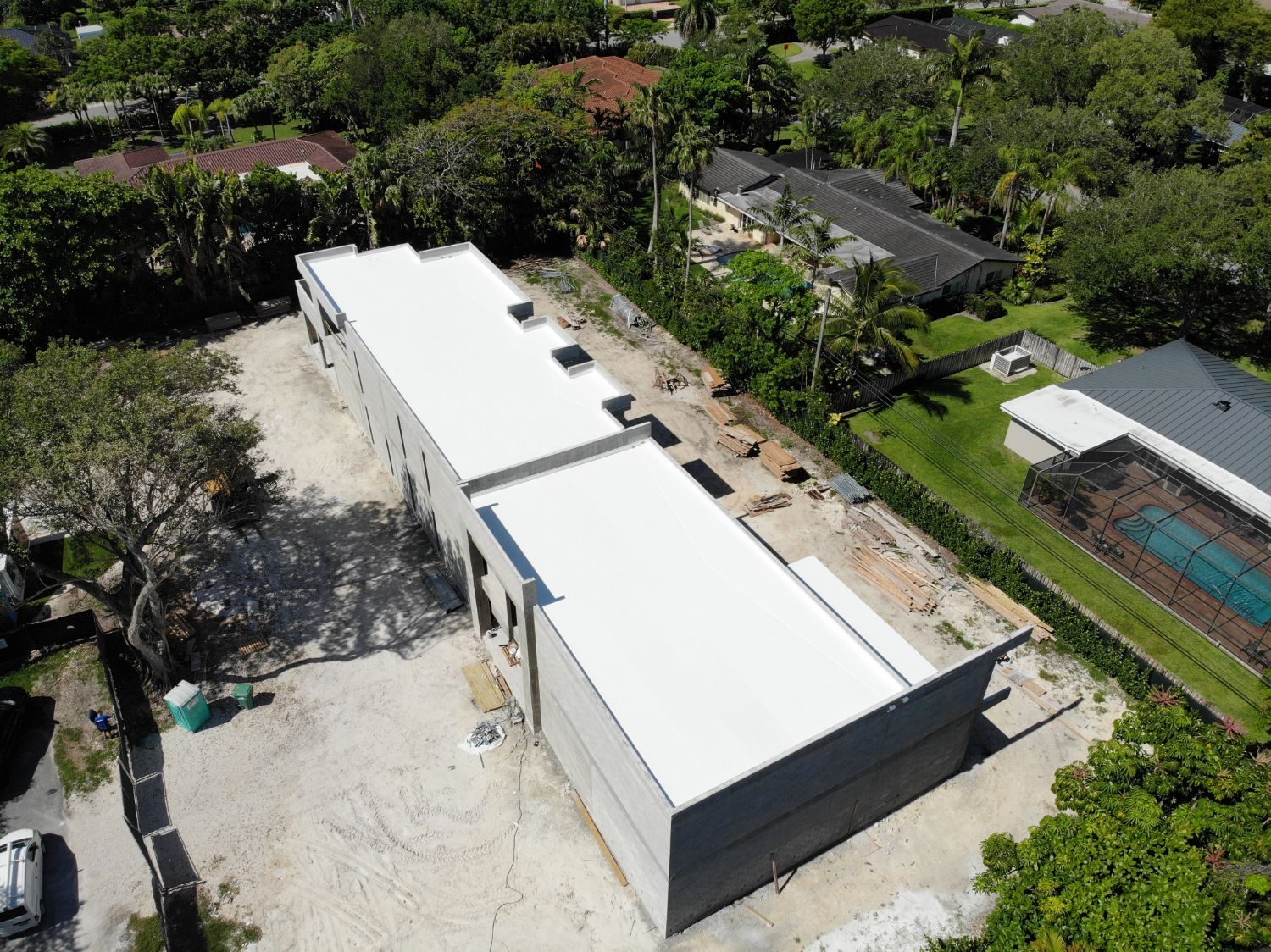 White TPO roof on a new construction home in South Florida, installed by Skymen Roofing